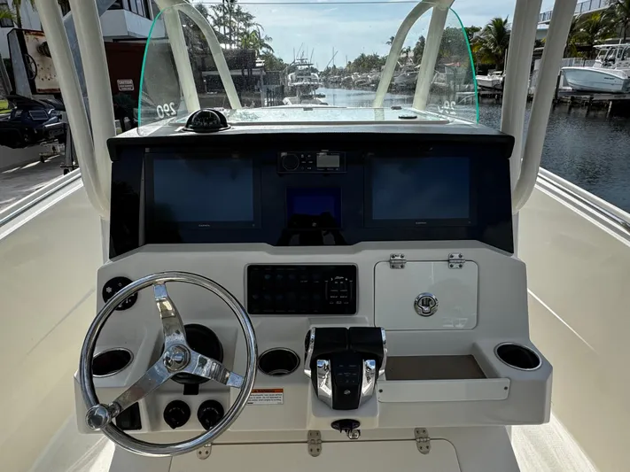  Yacht Photos Pics Center console of 2022 Sailfish 290 CC boat with steering wheel and navigation screens.