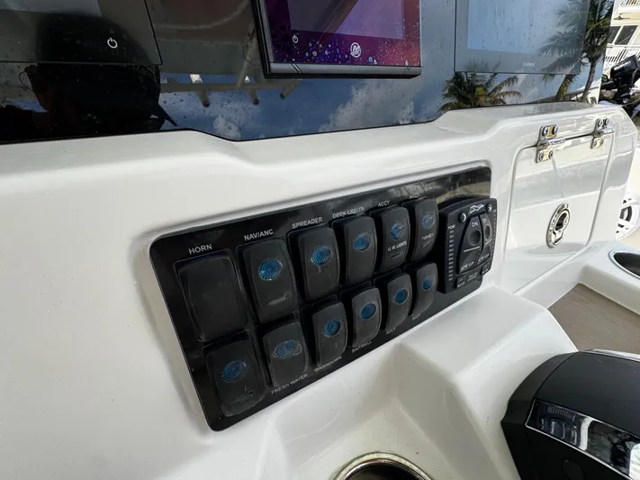  Yacht Photos Pics Control panel of 2022 Sailfish 290 CC boat with labeled switches and displays.