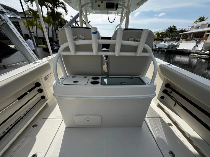  Yacht Photos Pics 2022 Sailfish 290 CC boat interior with seating and storage, docked by a marina.