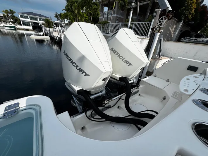  Yacht Photos Pics Twin Mercury outboard engines on a 2022 Sailfish 290 CC boat docked by the water.
