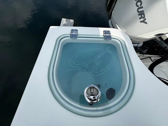  Yacht Photos Pics 2022 Sailfish 290 CC livewell with transparent lid and Mercury engine in background.
