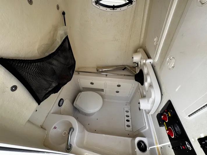  Yacht Photos Pics 2022 Sailfish 290 CC boat interior with compact bathroom and storage features.