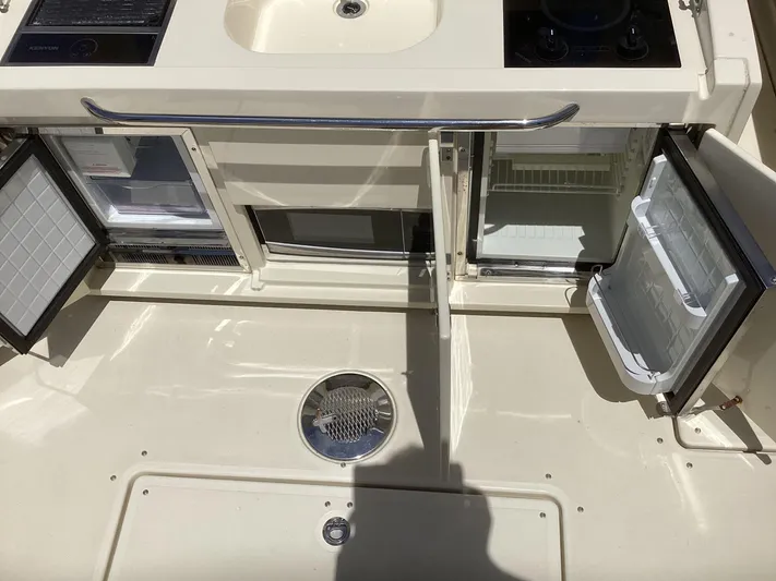  Yacht Photos Pics 2016 Chris-Craft 34 Catalina boat kitchen area with open fridge and sink.
