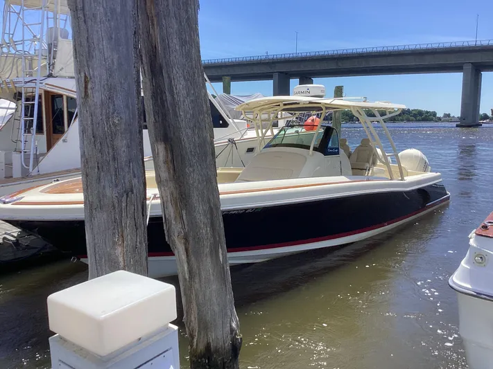  Yacht Photos Pics 2016 Chris-Craft 34 Catalina boat docked near a bridge on a sunny day.