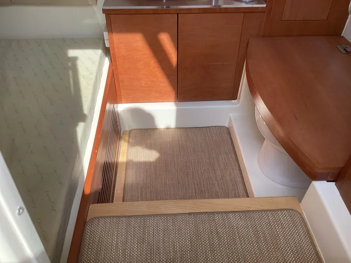  Yacht Photos Pics Interior of 2016 Chris-Craft 34 Catalina, featuring wooden cabinetry and cushioned seating.