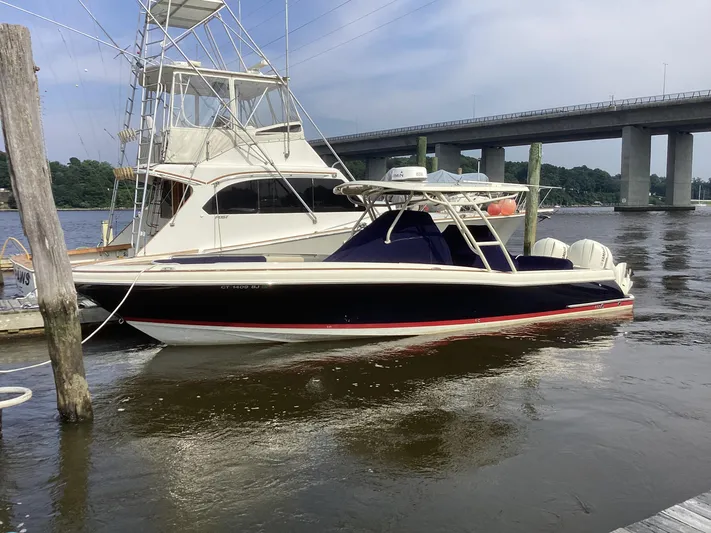  Yacht Photos Pics 2016 Chris-Craft 34 Catalina boat docked near a bridge on a calm river.