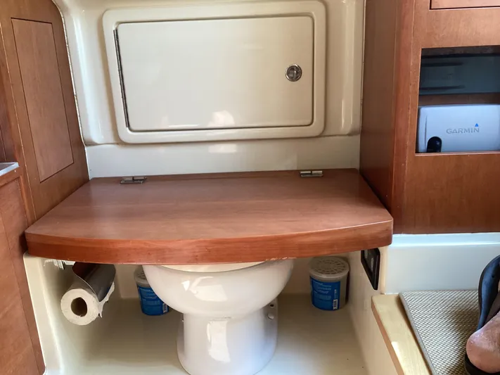  Yacht Photos Pics 2016 Chris-Craft 34 Catalina boat bathroom with wooden accents and storage.