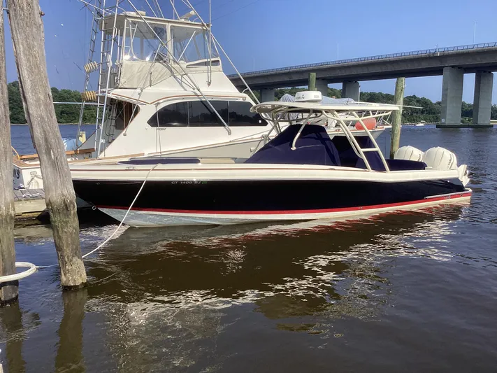  Yacht Photos Pics 2016 Chris-Craft 34 Catalina boat docked near a bridge on a sunny day.