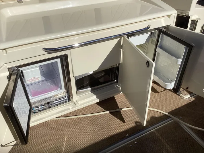  Yacht Photos Pics 2016 Chris-Craft 34 Catalina interior with open storage and refrigerator compartments.