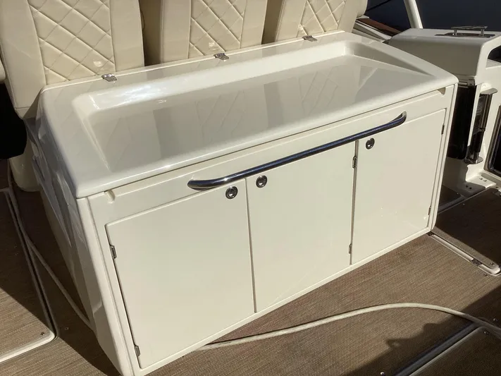  Yacht Photos Pics 2016 Chris-Craft 34 Catalina boat interior with white storage compartment and cushioned seating.