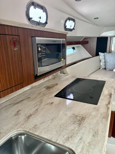  Yacht Photos Pics 2018 Pursuit OS 355 Offshore yacht interior with modern kitchen and appliances.