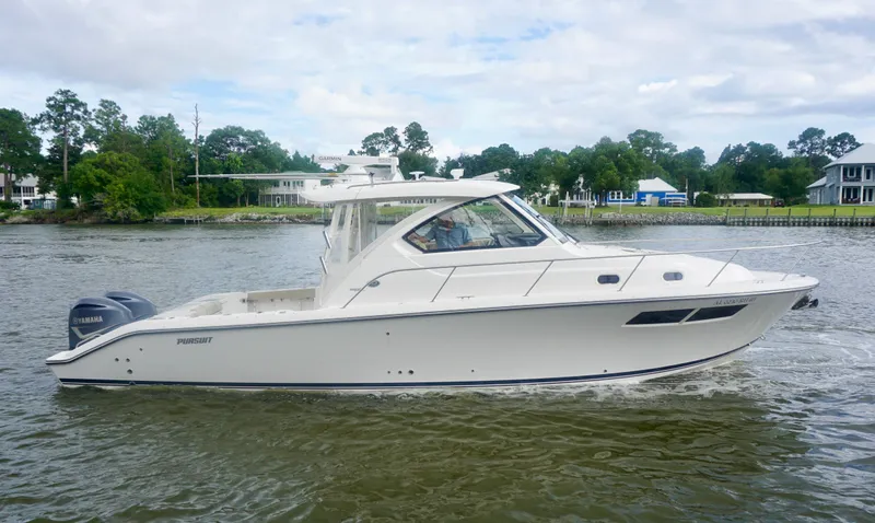  Yacht Photos Pics 2018 Pursuit OS 355 Offshore boat cruising on a calm river with scenic background.
