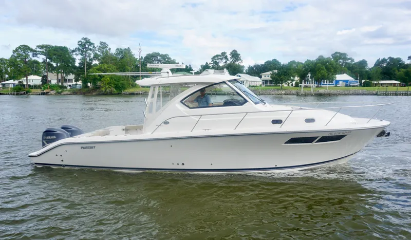  Yacht Photos Pics 2018 Pursuit OS 355 Offshore boat cruising on a river with scenic background.