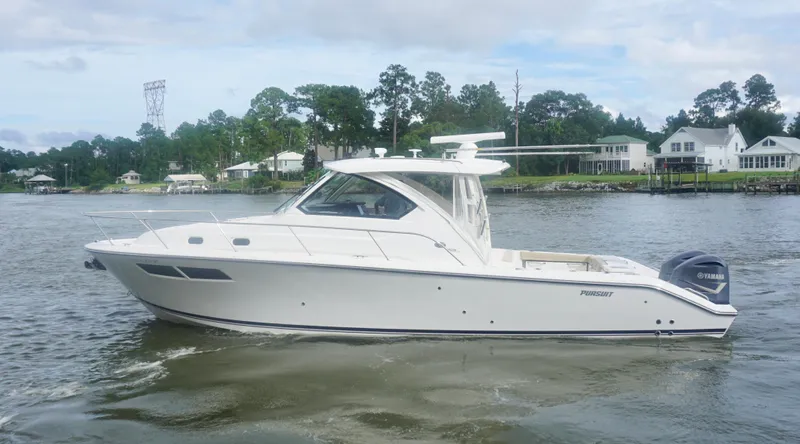  Yacht Photos Pics 2018 Pursuit OS 355 Offshore boat cruising on a calm river near waterfront homes.