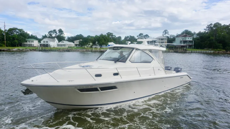  Yacht Photos Pics 2018 Pursuit OS 355 Offshore boat cruising on a scenic waterway.