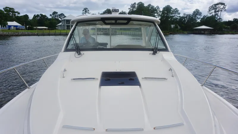  Yacht Photos Pics 2018 Pursuit OS 355 Offshore boat on water, front view with cabin and windshield.