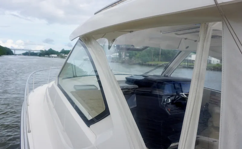  Yacht Photos Pics 2018 Pursuit OS 355 Offshore boat on a calm river, showcasing sleek design and cockpit.