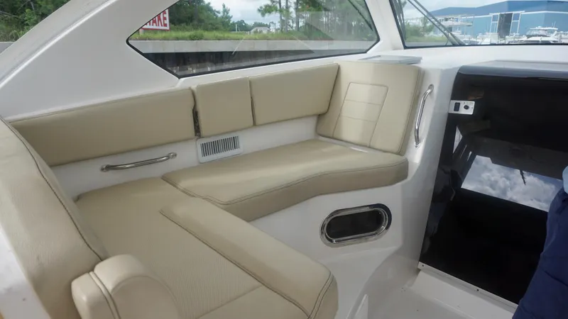  Yacht Photos Pics 2018 Pursuit OS 355 Offshore boat interior with beige seating and modern design.