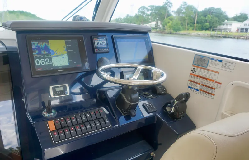  Yacht Photos Pics 2018 Pursuit OS 355 Offshore helm with navigation screens and controls.