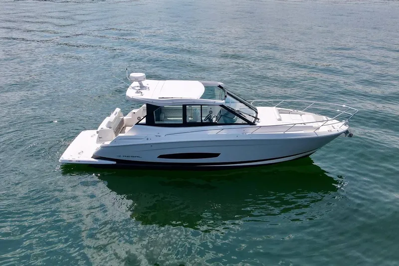  Yacht Photos Pics 2021 Regal 36 Grande Coupe boat cruising on calm water.