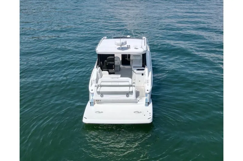  Yacht Photos Pics 2021 Regal 36 Grande Coupe yacht on calm blue water, rear view.