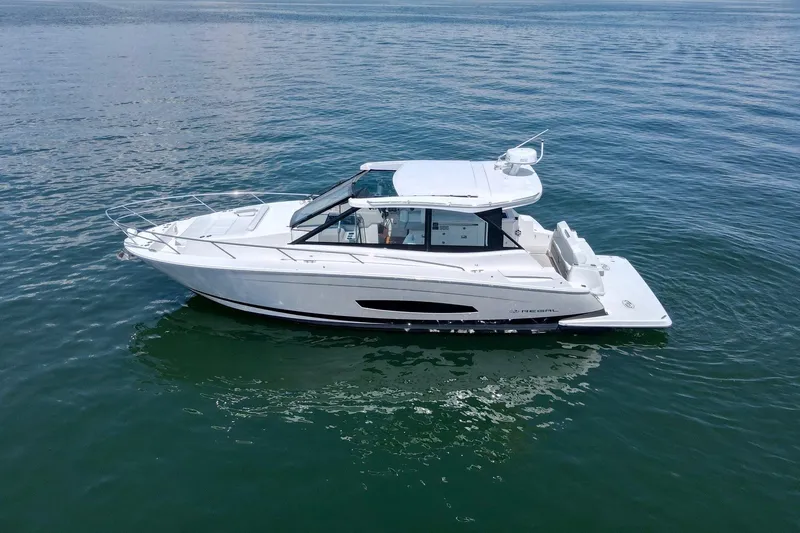  Yacht Photos Pics 2021 Regal 36 Grande Coupe boat cruising on calm blue waters.