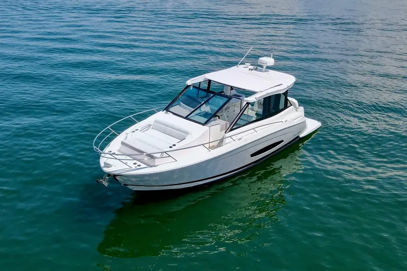  Yacht Photos Pics 2021 Regal 36 Grande Coupe yacht on calm blue water.