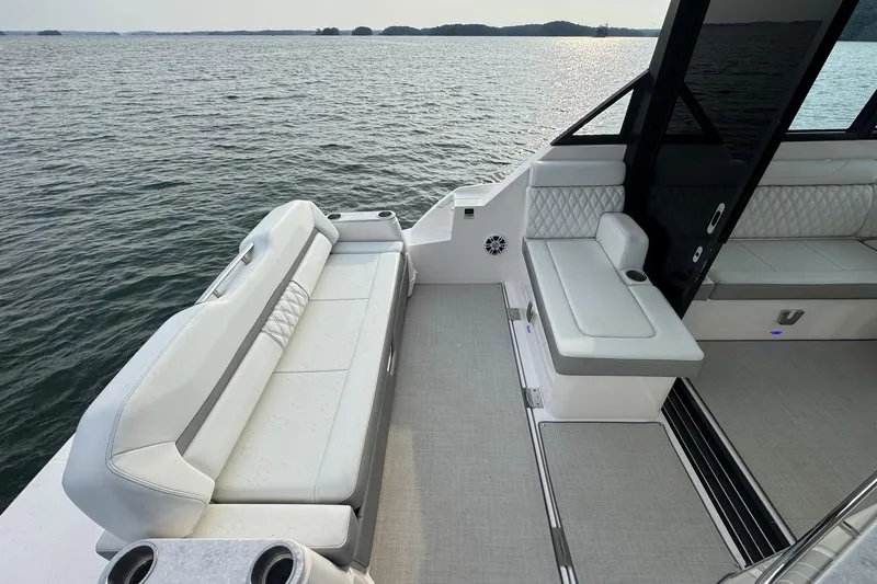 Yacht Photos Pics 2021 Regal 36 Grande Coupe boat interior with luxurious seating on a serene lake.