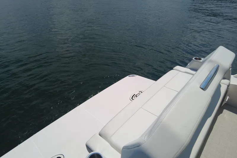  Yacht Photos Pics 2021 Regal 36 Grande Coupe boat with white seating by the water.