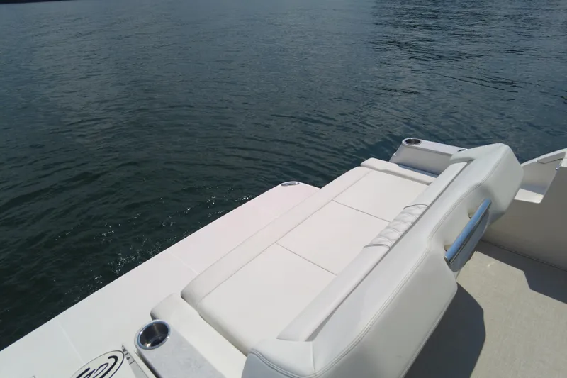  Yacht Photos Pics 2021 Regal 36 Grande Coupe boat with white seating, overlooking calm water.