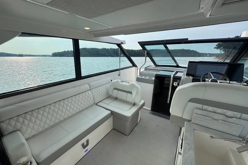  Yacht Photos Pics Interior of 2021 Regal 36 Grande Coupe yacht with luxurious seating and scenic water view.