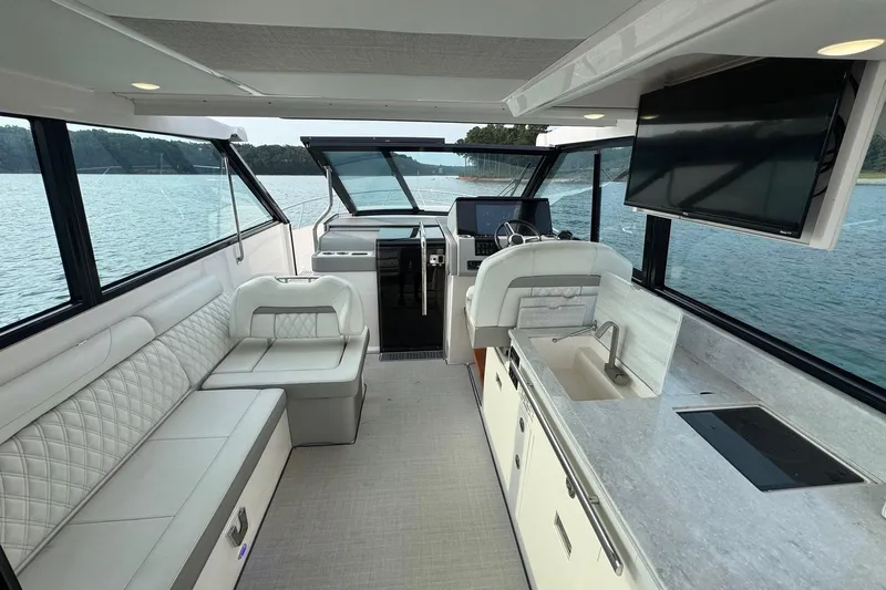  Yacht Photos Pics Luxurious interior of 2021 Regal 36 Grande Coupe yacht with modern amenities and scenic water view.