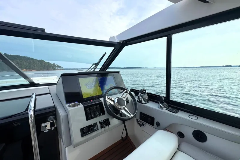  Yacht Photos Pics Interior view of 2021 Regal 36 Grande Coupe boat cockpit with navigation system.