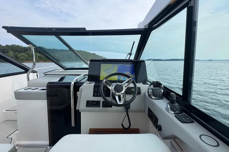  Yacht Photos Pics 2021 Regal 36 Grande Coupe helm with navigation system on open water.