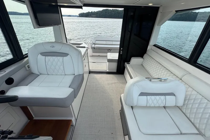  Yacht Photos Pics Luxurious interior of 2021 Regal 36 Grande Coupe yacht with white seating and lake view.