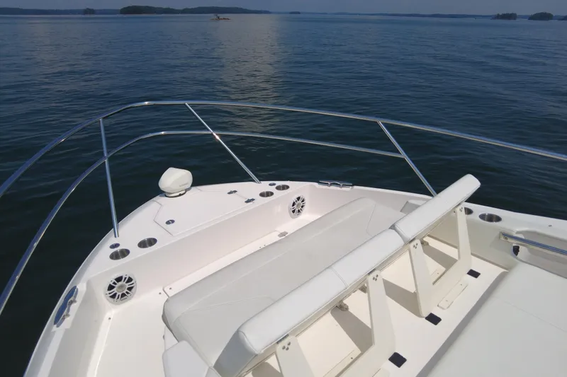  Yacht Photos Pics 2021 Regal 36 Grande Coupe boat deck with seating, overlooking calm waters.