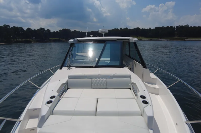  Yacht Photos Pics 2021 Regal 36 Grande Coupe on serene lake with plush seating and sleek design.