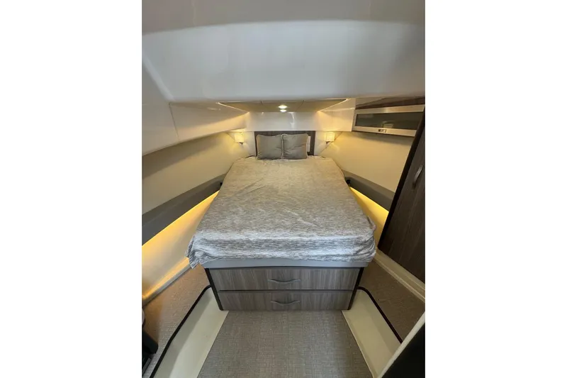  Yacht Photos Pics Luxurious cabin interior of 2021 Regal 36 Grande Coupe with cozy bed and ambient lighting.