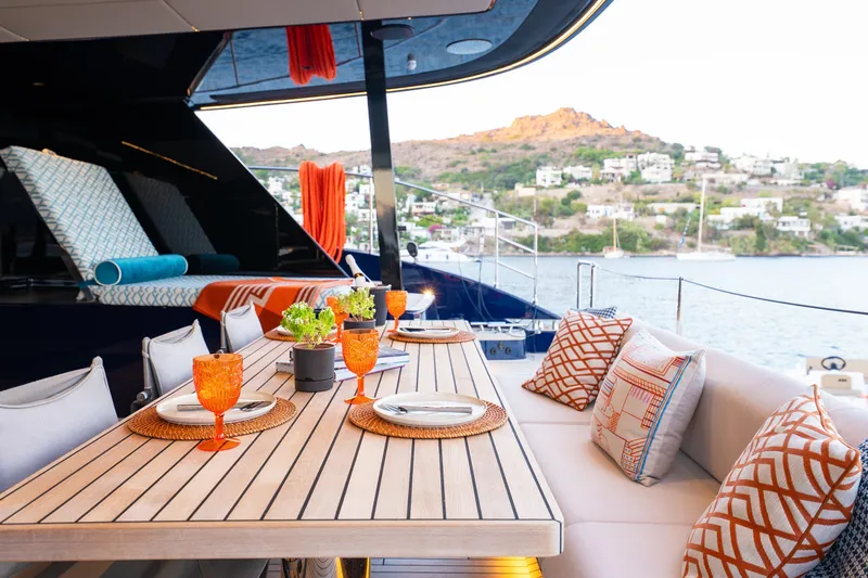  Yacht Photos Pics Luxurious 2024 Sunreef 60 Eco yacht deck with elegant dining setup and scenic ocean view.
