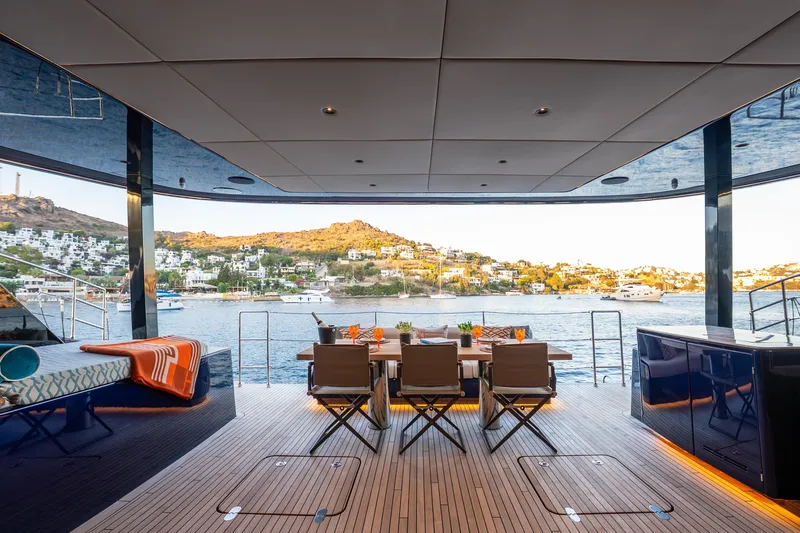  Yacht Photos Pics Luxurious Sunreef 60 Eco yacht deck with dining area, overlooking scenic coastal view, 2024 model.