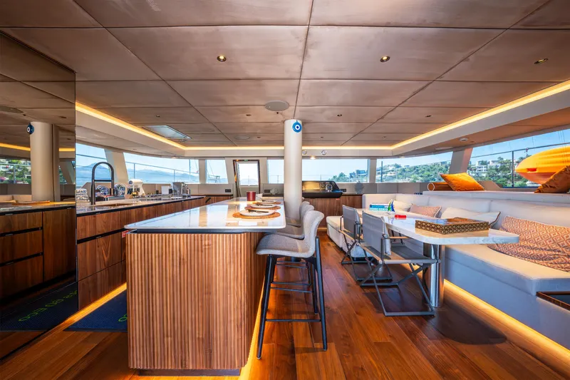  Yacht Photos Pics Luxurious interior of 2024 Sunreef 60 Eco yacht with modern kitchen and seating area.