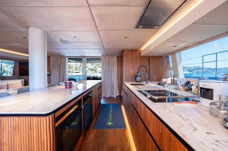  Yacht Photos Pics Luxurious interior of 2024 Sunreef 60 Eco yacht with modern kitchen design.