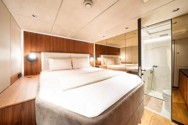  Yacht Photos Pics Luxurious bedroom interior of 2024 Sunreef 60 Eco yacht with modern design and ensuite bathroom.