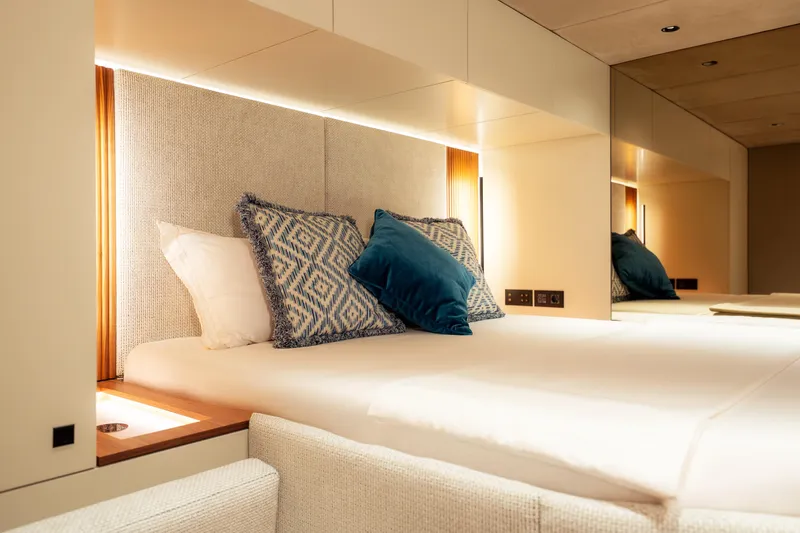  Yacht Photos Pics Luxurious bedroom interior of 2024 Sunreef 60 Eco yacht with elegant bedding and ambient lighting.