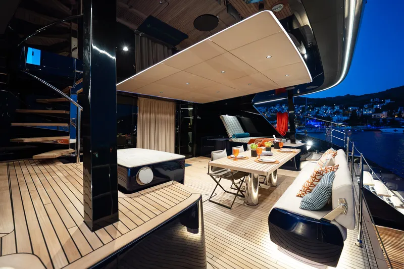  Yacht Photos Pics Luxurious 2024 Sunreef 60 Eco yacht deck with elegant dining setup at sunset.