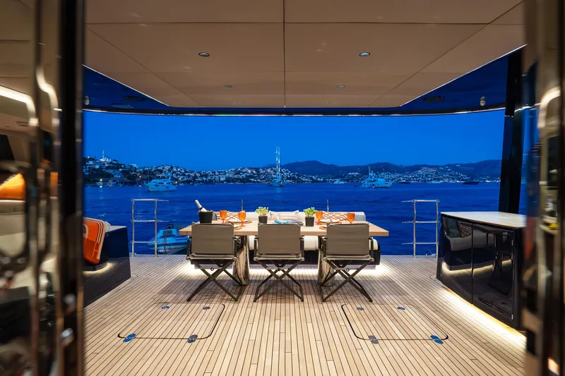  Yacht Photos Pics Luxurious Sunreef 60 Eco yacht deck with elegant dining setup, overlooking serene evening waters.