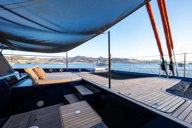  Yacht Photos Pics 2024 Sunreef 60 Eco yacht deck with sunshade, overlooking serene ocean and distant mountains.