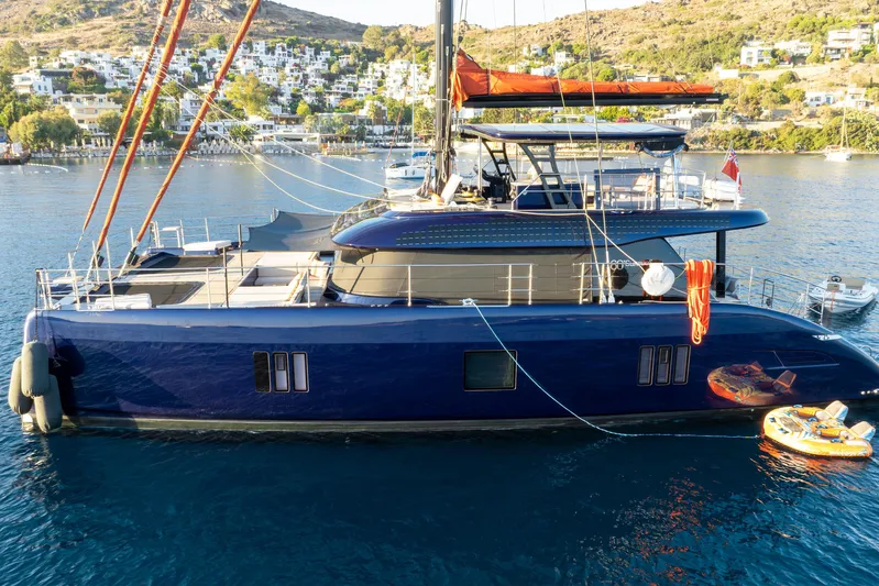  Yacht Photos Pics 2024 Sunreef 60 Eco yacht docked in a scenic coastal area.