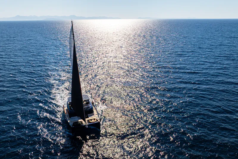  Yacht Photos Pics Sailing Sunreef 60 Eco yacht on shimmering ocean, 2024 model.