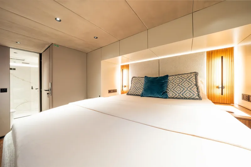  Yacht Photos Pics Luxurious bedroom interior of 2024 Sunreef 60 Eco yacht with modern design and elegant lighting.